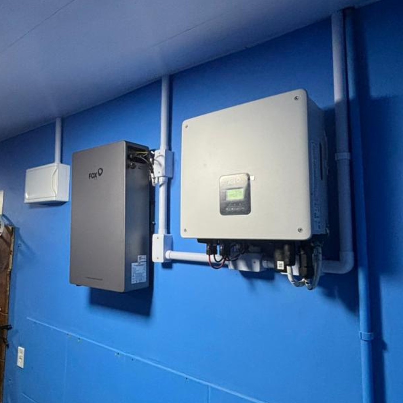 Inversor e bateria FoxESS instalados em parede técnica em Joinville